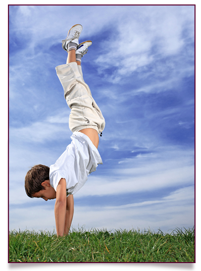 Boy doing yoga handstand